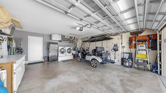 1613 E Del Webb Blvd, Sun City Center, FL 33573 - garage featuring washer and dryer, a garage door opener, and freestanding refrigerator