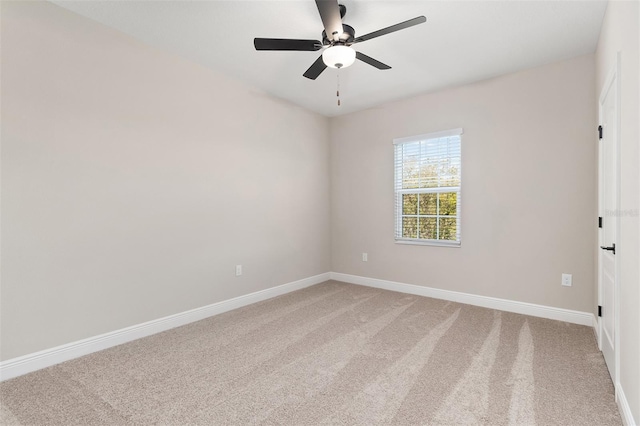 unfurnished room with baseboards, light colored carpet, and ceiling fan