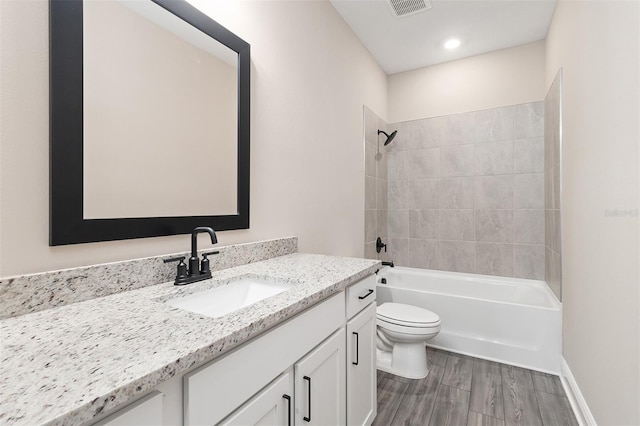 full bathroom featuring vanity, toilet, visible vents, bathtub / shower combination, and wood finished floors