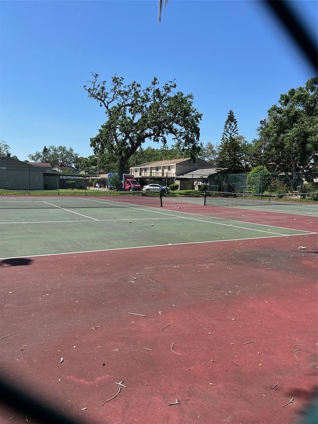 view of tennis court with fence