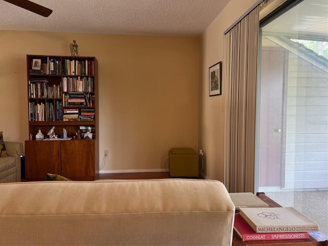 sitting room featuring a textured ceiling and ceiling fan