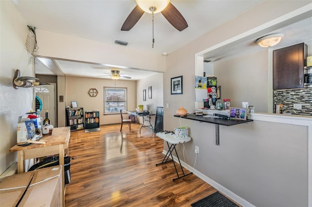 1025 W Berry Ave, Tampa, FL 33603 - kitchen featuring dark brown cabinets, visible vents, backsplash, wood finished floors, and ceiling fan