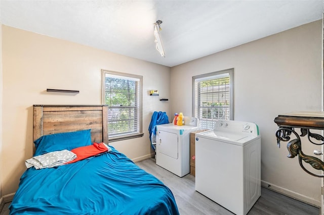 1025 W Berry Ave, Tampa, FL 33603 - laundry area featuring plenty of natural light, light wood-style floors, independent washer and dryer, and laundry area