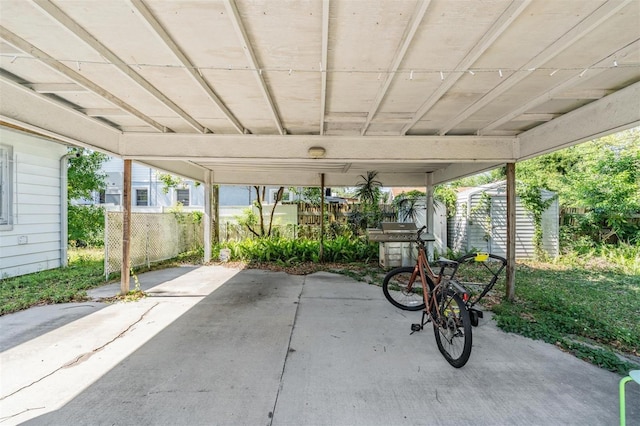 1025 W Berry Ave, Tampa, FL 33603 - view of patio / terrace featuring fence, an outbuilding, and a storage unit