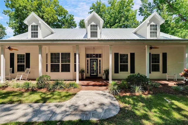 16420 Iola Woods Trl, Dade City, FL 33523 - view of front of house with covered porch, a ceiling fan, and metal roof
