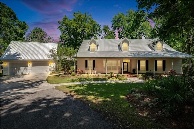 16420 Iola Woods Trl, Dade City, FL 33523 - farmhouse-style home featuring a detached garage, a front lawn, covered porch, and driveway