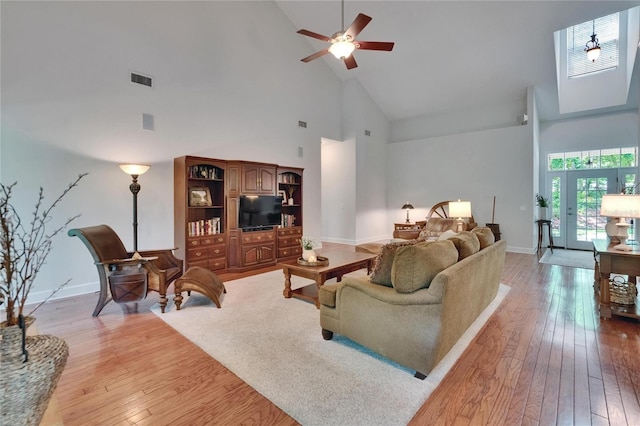 16420 Iola Woods Trl, Dade City, FL 33523 - living room with light wood-type flooring, high vaulted ceiling, ceiling fan, and baseboards
