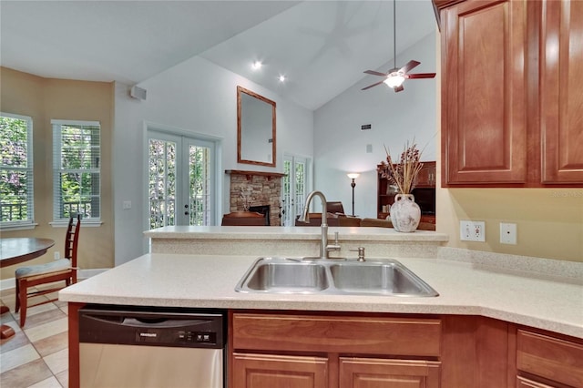 16420 Iola Woods Trl, Dade City, FL 33523 - kitchen with dishwasher, a sink, light countertops, a stone fireplace, and a ceiling fan