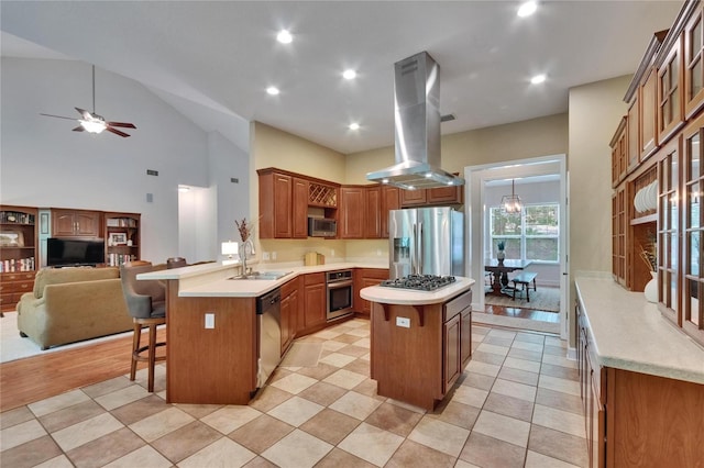 16420 Iola Woods Trl, Dade City, FL 33523 - kitchen with a kitchen breakfast bar, a peninsula, a kitchen island, appliances with stainless steel finishes, and island exhaust hood