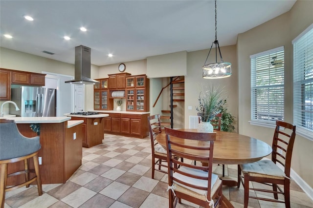 16420 Iola Woods Trl, Dade City, FL 33523 - kitchen featuring a kitchen breakfast bar, island exhaust hood, a center island, light countertops, and stainless steel refrigerator with ice dispenser