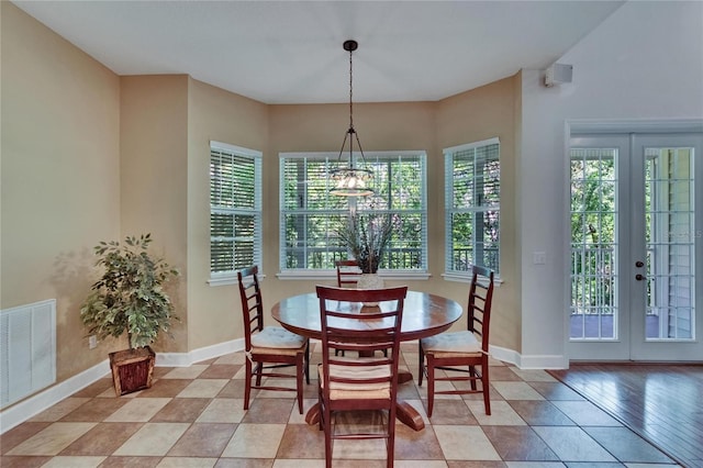 16420 Iola Woods Trl, Dade City, FL 33523 - dining space with french doors, visible vents, baseboards, and an inviting chandelier