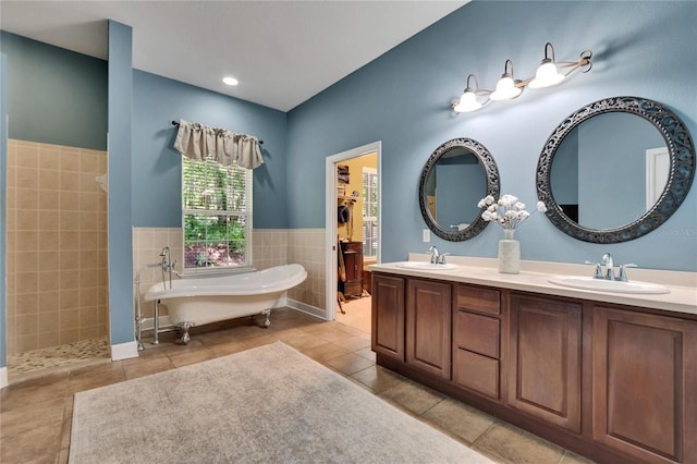 16420 Iola Woods Trl, Dade City, FL 33523 - bathroom with a sink, a freestanding bath, and tile patterned flooring