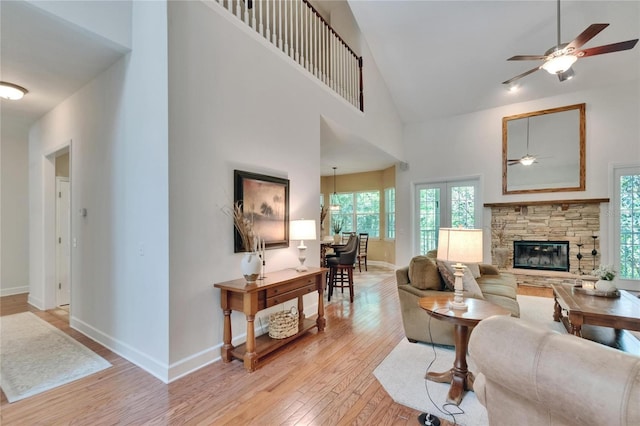 16420 Iola Woods Trl, Dade City, FL 33523 - living room featuring baseboards, high vaulted ceiling, light wood-type flooring, and a ceiling fan