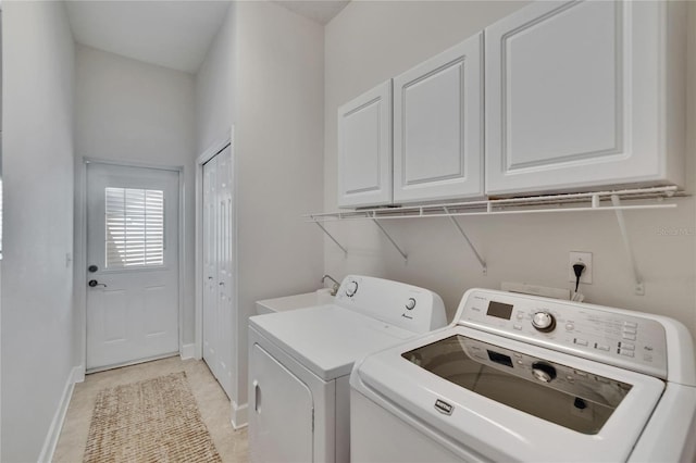 16420 Iola Woods Trl, Dade City, FL 33523 - clothes washing area with baseboards, a sink, washing machine and clothes dryer, and cabinet space