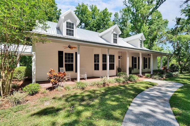 16420 Iola Woods Trl, Dade City, FL 33523 - view of front facade featuring metal roof, a front lawn, and ceiling fan