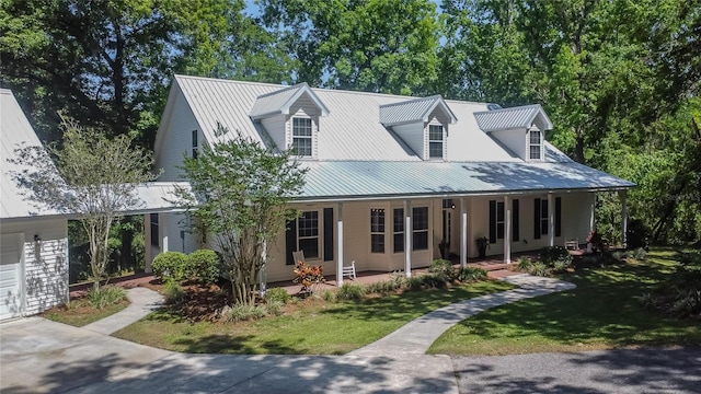16420 Iola Woods Trl, Dade City, FL 33523 - view of front of home with covered porch, a front lawn, and metal roof
