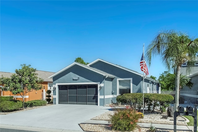 8116 Sanguinelli Rd, Land O Lakes, FL 34637 - view of front of property featuring stucco siding, concrete driveway, fence, and a garage