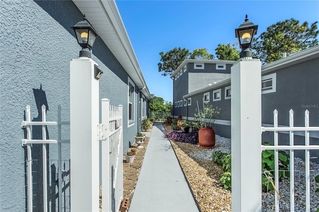 8116 Sanguinelli Rd, Land O Lakes, FL 34637 - view of property exterior with stucco siding and fence