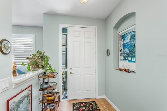 8116 Sanguinelli Rd, Land O Lakes, FL 34637 - entryway with baseboards and light tile patterned floors
