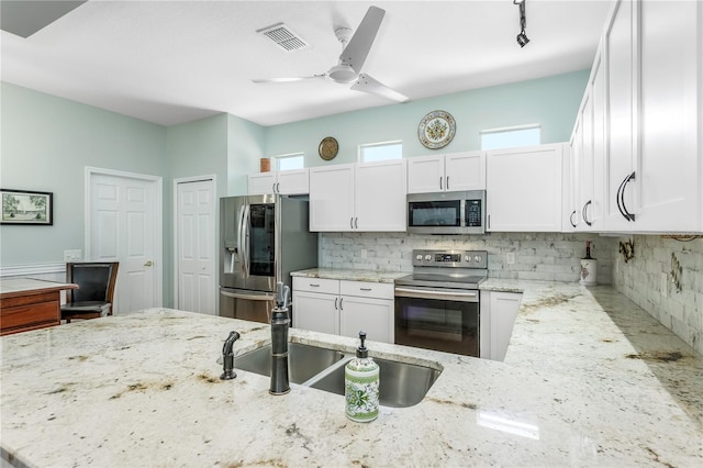 8116 Sanguinelli Rd, Land O Lakes, FL 34637 - kitchen featuring visible vents, a sink, white cabinetry, and appliances with stainless steel finishes