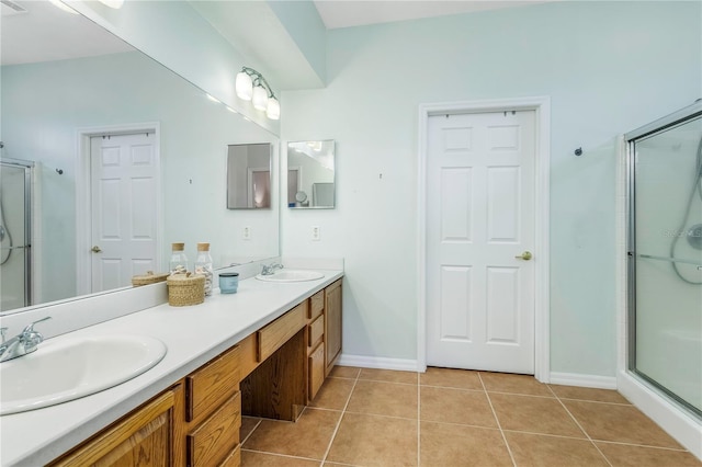 8116 Sanguinelli Rd, Land O Lakes, FL 34637 - full bathroom featuring tile patterned floors, a sink, a shower stall, and double vanity