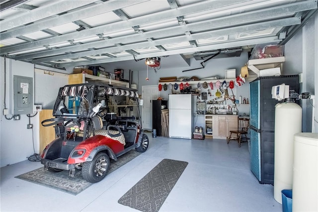 8116 Sanguinelli Rd, Land O Lakes, FL 34637 - garage featuring freestanding refrigerator, electric panel, and a garage door opener