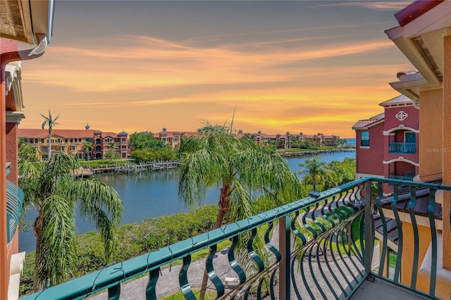 2746 Via Tivoli Unit 135A, Clearwater, FL 33764 - balcony at dusk featuring a water view and a residential view