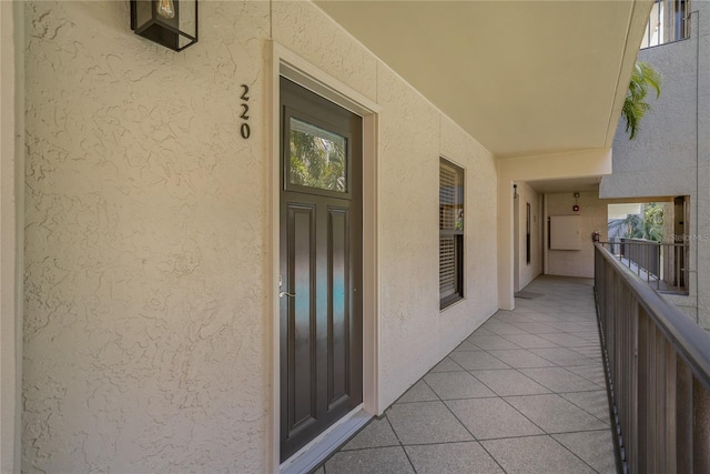 105 4th Ave NE Unit 220, Saint Petersburg, FL 33701 - doorway to property featuring a balcony and stucco siding