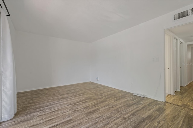 105 4th Ave NE Unit 220, Saint Petersburg, FL 33701 - empty room with visible vents, baseboards, and wood finished floors
