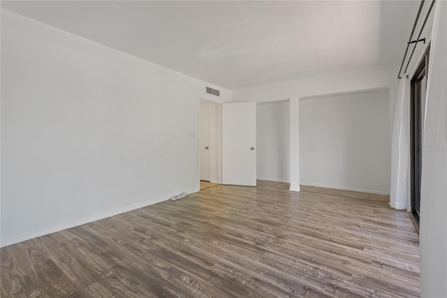 105 4th Ave NE Unit 220, Saint Petersburg, FL 33701 - empty room featuring visible vents, baseboards, and wood finished floors