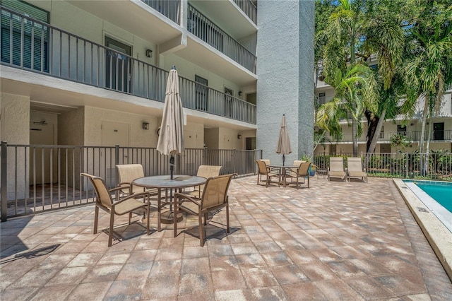 105 4th Ave NE Unit 220, Saint Petersburg, FL 33701 - view of patio with outdoor dining area and fence