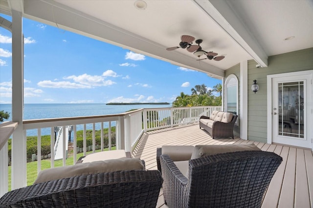 wooden terrace featuring a ceiling fan and a water view