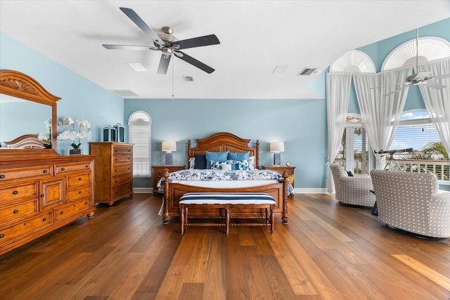 bedroom featuring hardwood / wood-style floors, a ceiling fan, and baseboards