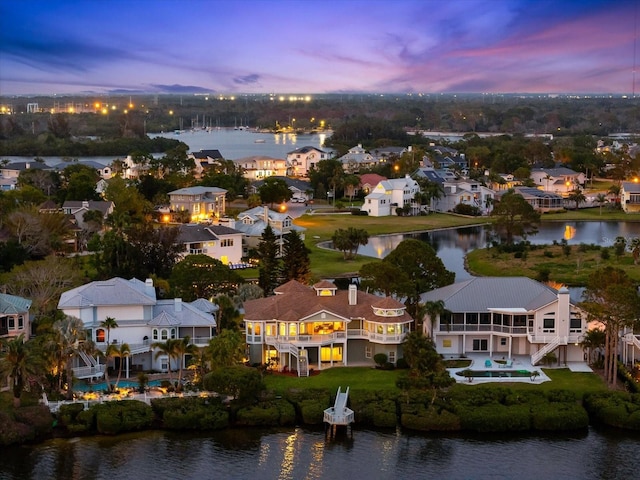birds eye view of property with a water view and a residential view