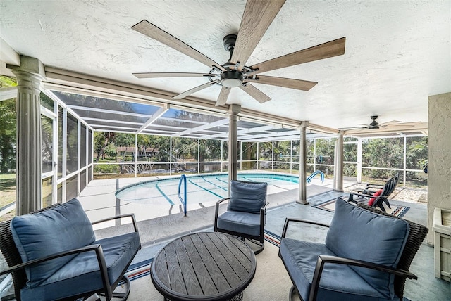 pool featuring a lanai, a patio, and ceiling fan