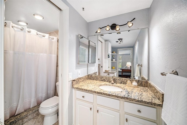 full bathroom featuring tile patterned floors, vanity, a shower with curtain, and toilet