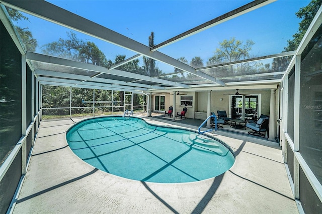 outdoor pool featuring a patio, a lanai, and a ceiling fan
