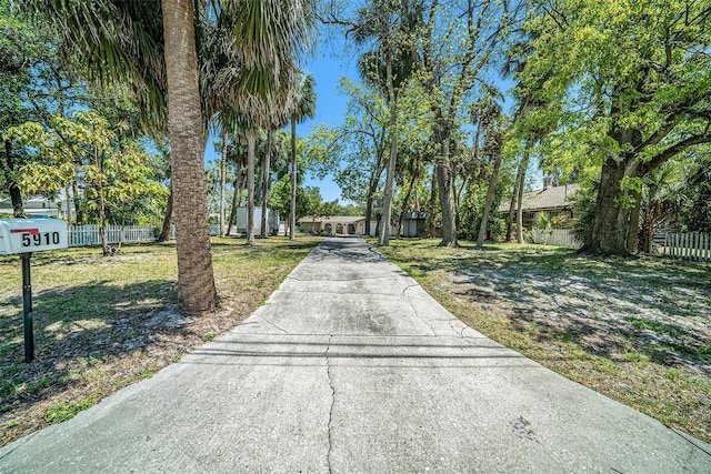 view of road featuring concrete driveway