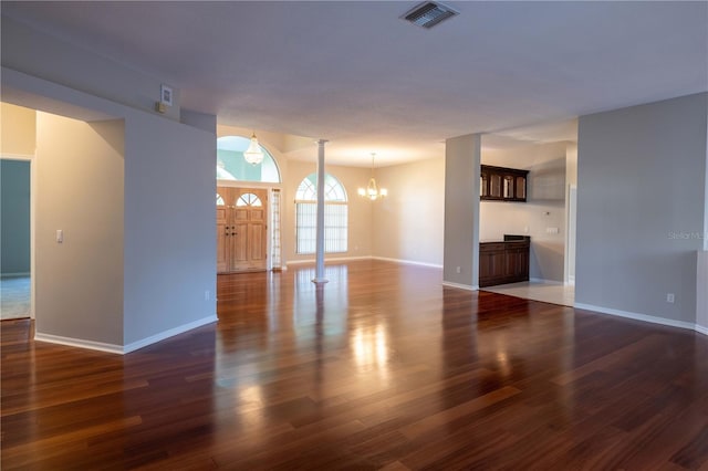 9159 Highland Ridge Way, Tampa, FL 33647 - unfurnished living room featuring baseboards, wood finished floors, a notable chandelier, and visible vents