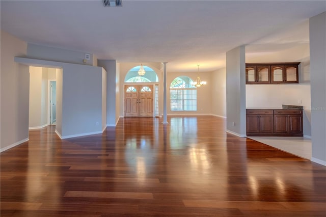 9159 Highland Ridge Way, Tampa, FL 33647 - unfurnished living room with visible vents, dark wood-style flooring, a notable chandelier, and baseboards
