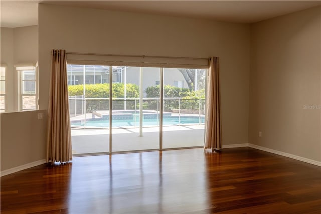 9159 Highland Ridge Way, Tampa, FL 33647 - unfurnished room featuring plenty of natural light, dark wood-style flooring, and baseboards