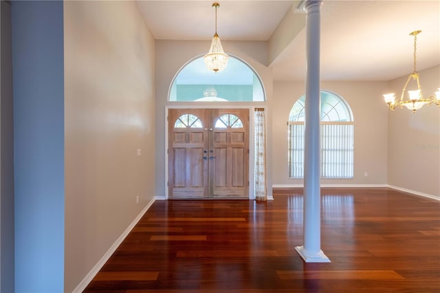 9159 Highland Ridge Way, Tampa, FL 33647 - entryway with decorative columns, a notable chandelier, baseboards, and wood finished floors