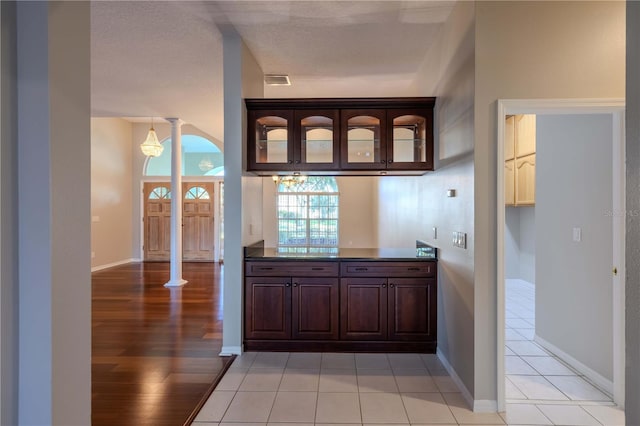 9159 Highland Ridge Way, Tampa, FL 33647 - bar with visible vents, baseboards, decorative columns, and light wood-type flooring