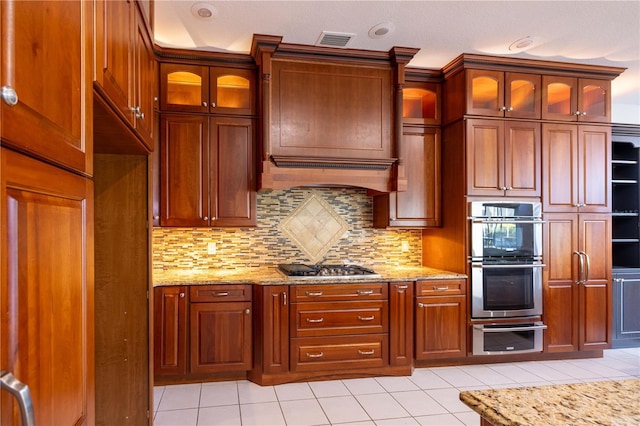 9159 Highland Ridge Way, Tampa, FL 33647 - kitchen with light stone countertops, tasteful backsplash, visible vents, light tile patterned flooring, and stainless steel appliances