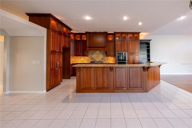 9159 Highland Ridge Way, Tampa, FL 33647 - kitchen featuring glass insert cabinets, baseboards, appliances with stainless steel finishes, backsplash, and light stone counters