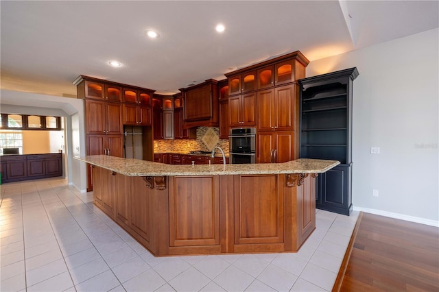 9159 Highland Ridge Way, Tampa, FL 33647 - kitchen featuring recessed lighting, light stone counters, appliances with stainless steel finishes, baseboards, and backsplash