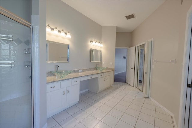 9159 Highland Ridge Way, Tampa, FL 33647 - bathroom featuring visible vents, a sink, double vanity, tile patterned flooring, and a stall shower