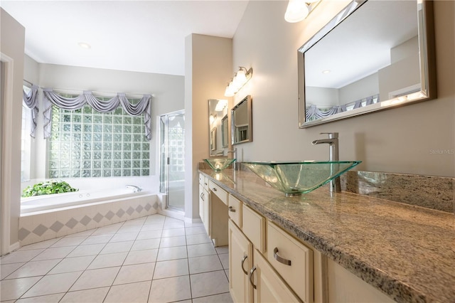 9159 Highland Ridge Way, Tampa, FL 33647 - bathroom featuring a bath, vanity, a shower with door, and tile patterned floors