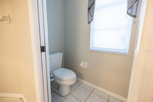 9159 Highland Ridge Way, Tampa, FL 33647 - bathroom with toilet, baseboards, and tile patterned flooring