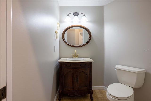 9159 Highland Ridge Way, Tampa, FL 33647 - half bathroom featuring toilet, vanity, baseboards, and tile patterned flooring